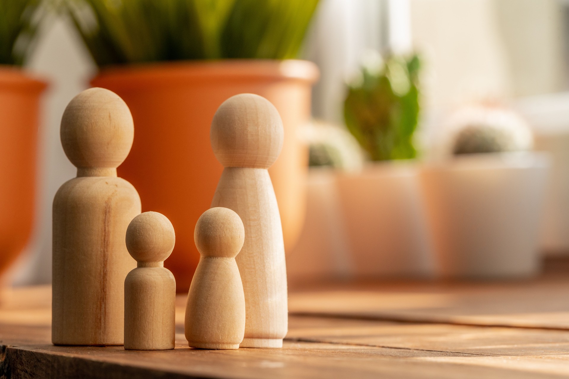 Small wooden figures of family members. Family relationship symbol